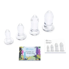 Complete b-Vibe glass dilator kit laid out with user guide and anal play booklet included