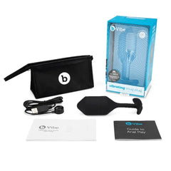 Complete b-Vibe Snug Plug kit laid out with storage pouch, USB cable, and instruction guides