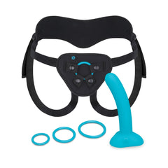 Complete b-Vibe strap-on set laid flat: black adjustable harness, teal dildo, and three O-rings