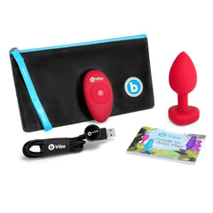 Complete kit: plug, remote, USB cable, storage pouch, and Guide to Anal Play booklet
