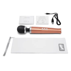 Complete Le Wand Die Cast kit laid flat showing massager, storage pouch, USB cable, and guides