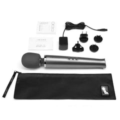 Complete Le Wand massager kit laid flat showing device, charger, adapters, storage bag, and user guides