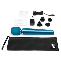 Complete Le Wand massager kit with pouch, charger, adaptor plugs, and user guide laid flat