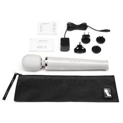 Complete Le Wand set: massager, storage pouch, charger, adapters, and user guide laid flat