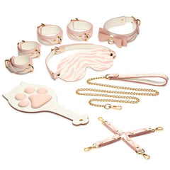 Complete Pink Kitty set laid flat: bow collar, zebra-print blindfold, wrist cuffs, ankle cuffs, hogtie connector, leash