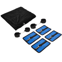 Complete Sportsheet kit laid flat: black fitted sheet, four blue hook pads, two wrist and ankle cuff pairs