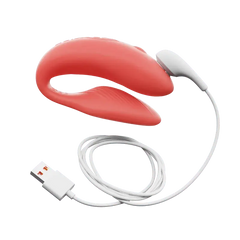 Coral Chorus couples vibrator connected to magnetic USB charging cable on white background
