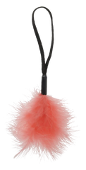 Close-up of coral marabou feather tickler suspended by black braided wrist strap, round shape