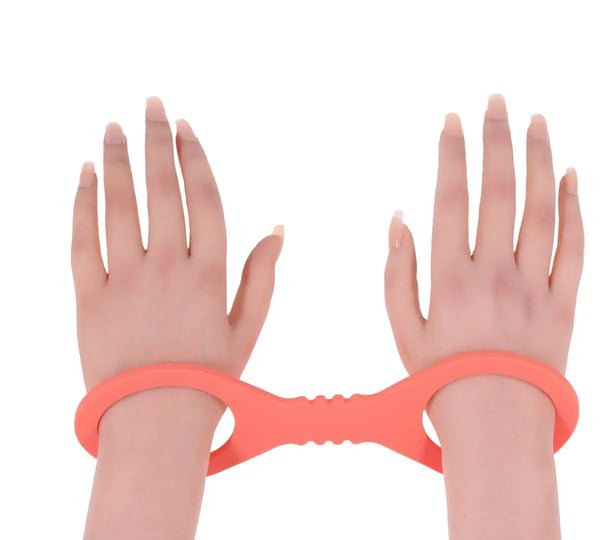 Coral silicone wrist cuffs worn on two wrists demonstrating fit and ring size