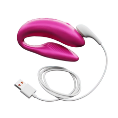 Cosmic Pink couples vibrator connected to white magnetic USB charging cable