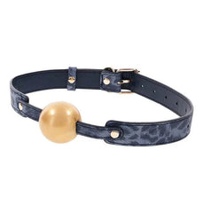 Close-up of Cougar Ball Gag leopard-texture strap with gold rivets securing the silicone ball