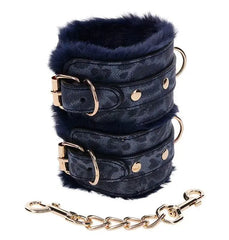 Close-up of Cougar Fur Handcuffs buckle, D-ring, snap clasp, and leopard-print vegan leather