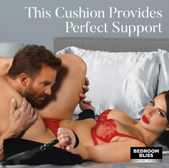 Couple on bed with black positioning bondage cushion providing hip and pelvic support