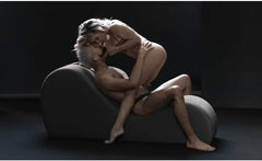 Couple using the Liberator Cello Chaise for intimate positioning, seated facing each other
