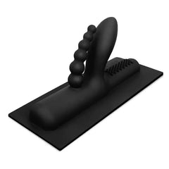 The Cowgirl Buckwild double penetration silicone attachment in matte black on a flat base
