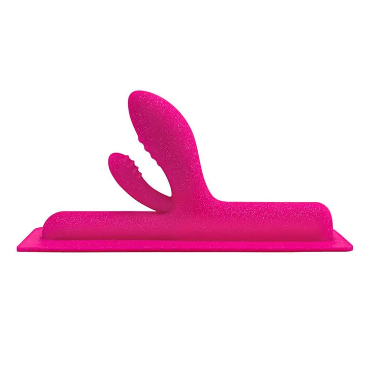 The Cowgirl Jackalope pink glitter silicone dual-stimulation attachment, front view on flat base