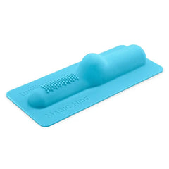 The Cowgirl Magic Hide vibrator attachment, angled top view showing textured ridged stimulator