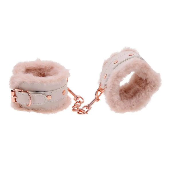 Cream leather and pink fur handcuffs open and displayed to show interior lining depth