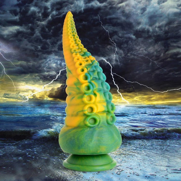 Creature Cocks Monstropus tentacled silicone dildo in green and yellow against stormy ocean backdrop