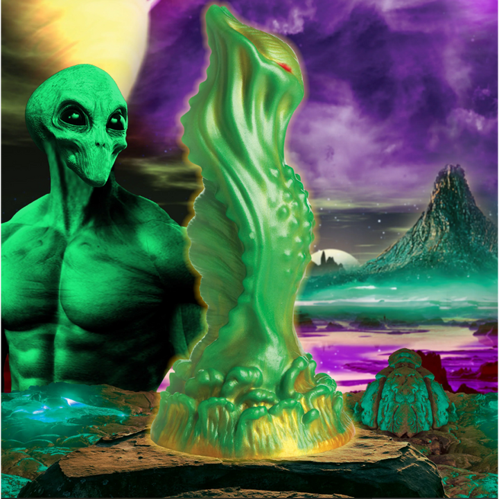 Creature Cocks Nebula Alien Silicone Dildo in green and gold against cosmic sci-fi backdrop