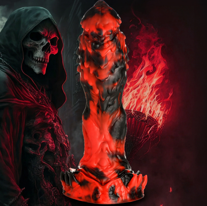 Creature Cocks Reaper Silicone Dildo in red and black beside a hooded skull figure