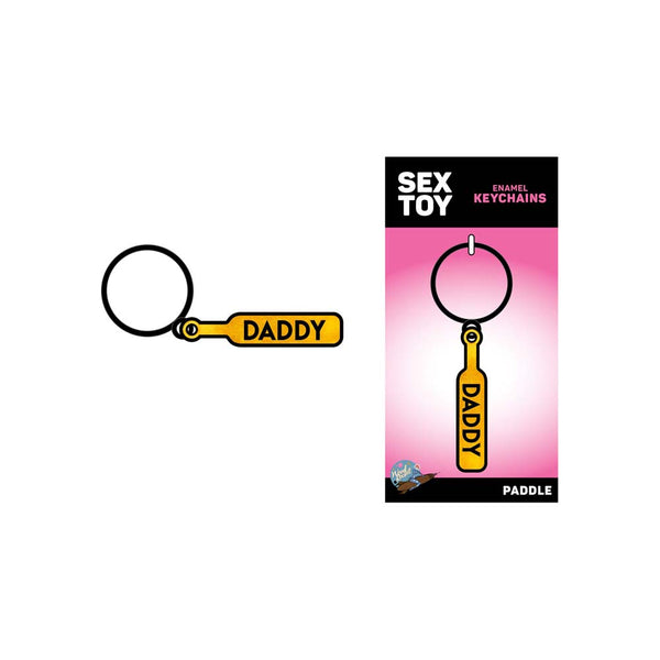 Daddy Paddle keychain beside its pink Sex Toy Enamel Keychains retail packaging card
