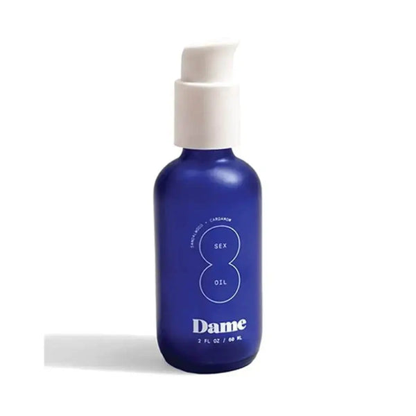 Dame Sex Oil in a cobalt blue glass pump bottle, 2 fl oz, on white background