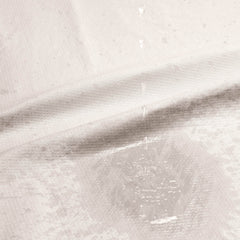Close-up of the Dame Throw fabric with water beading on the waterproof inner layer