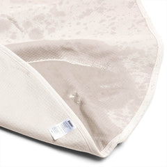 Dame Throw folded back to show the soft top surface and waterproof backing with care label