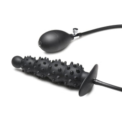 Deflated plug and pump bulb laid flat showing tubing connection and flared safety base