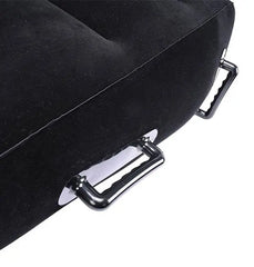 Detail of two chrome D-ring anchor points along base edge of black inflatable positioning wedge