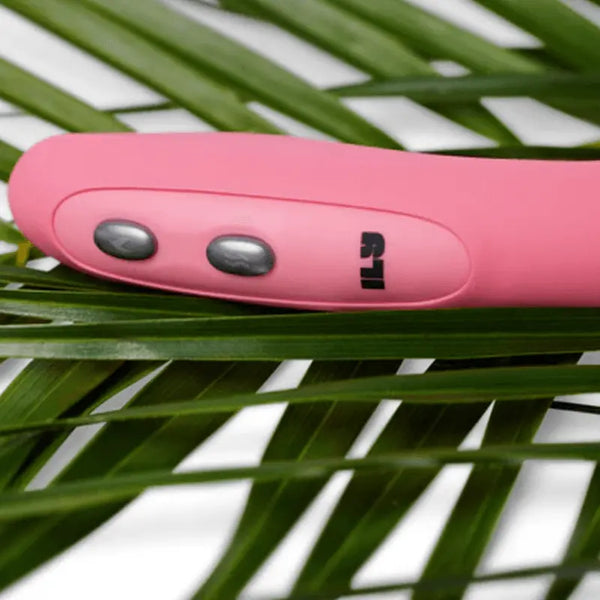 Detailed view of ILY Wand dual control buttons and brand logo on pink silicone