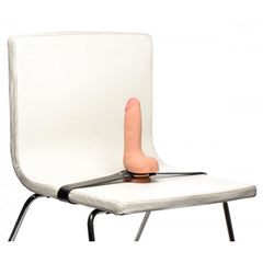 Dildo strap harness secured around white chair seat, demonstrating versatile mounting position