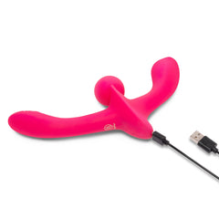 Double Tap pink silicone strap-on connected to USB charging cable showing charging setup