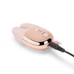 Double Vibe connected to magnetic USB charging cable at the base of rose gold body
