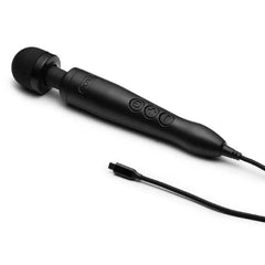 Doxy 3 matte black wand massager lying flat with USB-C charging cable detached beside it