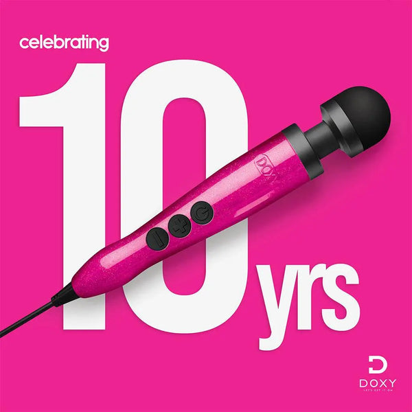 Doxy Die Cast 3 pink glitter wand massager displayed against pink background celebrating 10 years