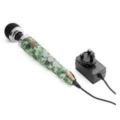 Doxy Die Cast 3 wand vibrator connected to UK plug-in power adapter on white surface