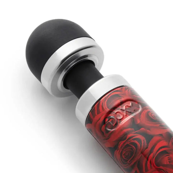 Close-up of Doxy Die Cast 3R black silicone massage head and chrome collar above rose-print handle