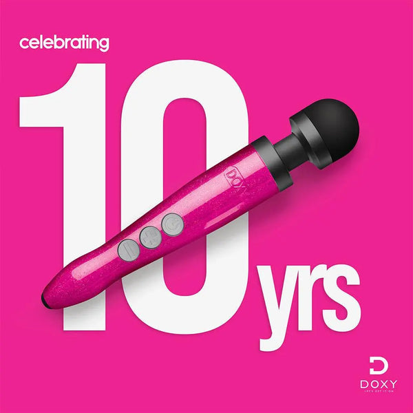 Doxy Die Cast 3R wand massager displayed against pink background celebrating 10 years