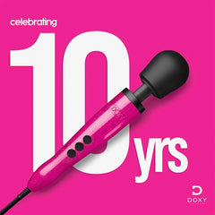 Doxy Die Cast pink wand massager displayed against a hot pink background marking the brand's 10th anniversary