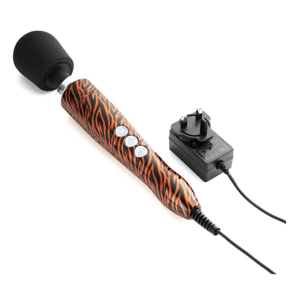 Doxy Die Cast Tiger wand massager laid flat beside its UK plug-in power adapter and cord