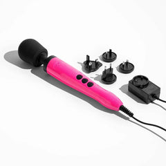 Doxy Die Cast wand massager laid flat beside a universal travel power adapter with four plug attachments