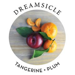 Dreamsicle scent profile label showing fresh tangerine and plum fruits on wood surface