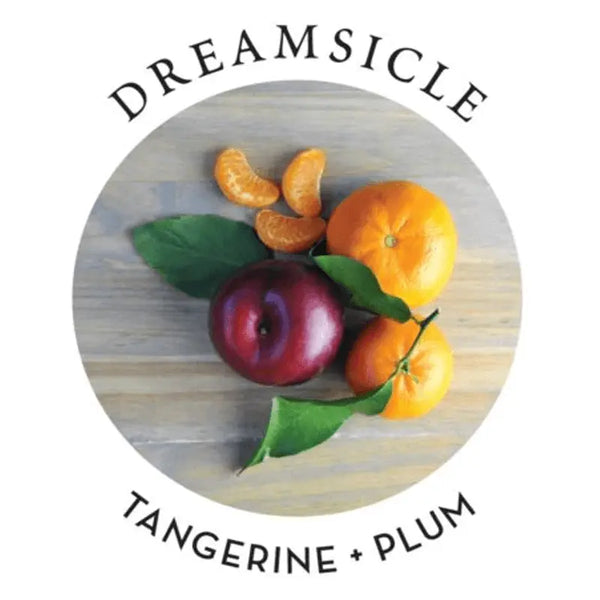 Dreamsicle scent profile label showing tangerine and plum fruits on a wooden surface