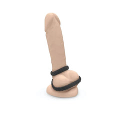 Dual silicone cock and ball ring set shown from front on upright realistic model