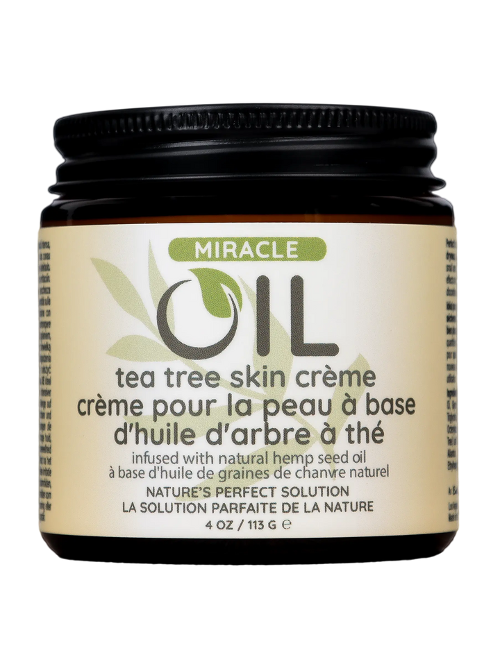 Earthly Body Miracle Oil Tea Tree Crème in an amber glass jar with black lid, 4 oz