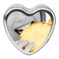 Earthly Body Pineapple Massage Candle in a silver heart-shaped tin with pineapple label art