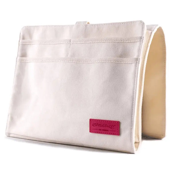 Womanizer Bedside Caddy in cream canvas with front pockets and pink brand label