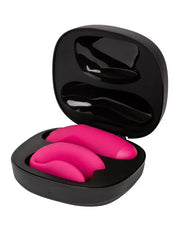 Electric pink Chorus Pro vibrators nestled in sleek black travel and charging case, lid open